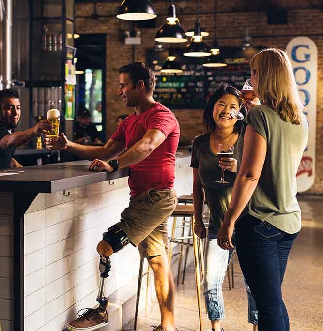 Disabled and Able bodied people having drinks at a bar