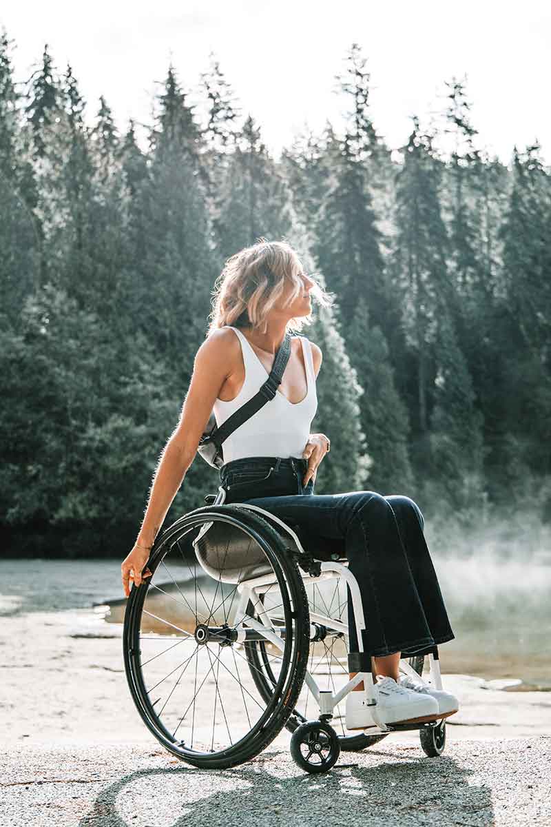Woman in wheelchair outside on a trail