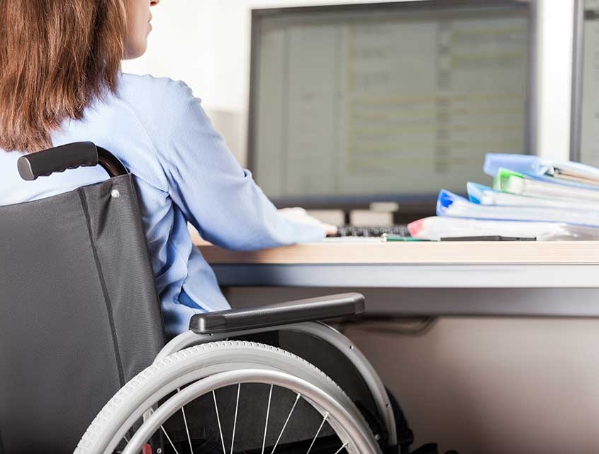 Woman in wheelchair working at computer